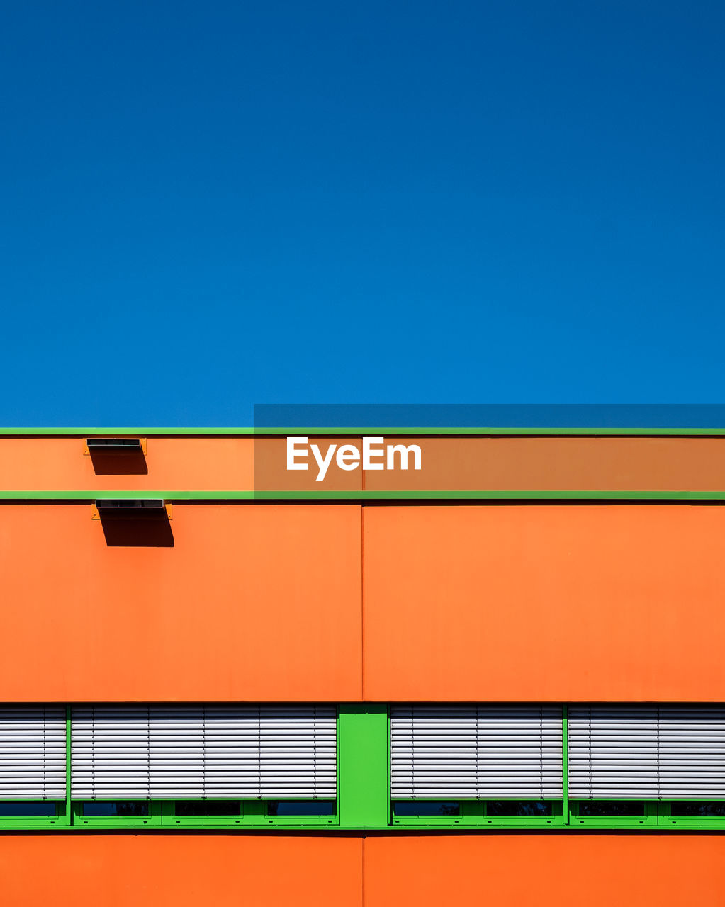 Low angle view of building against clear blue sky