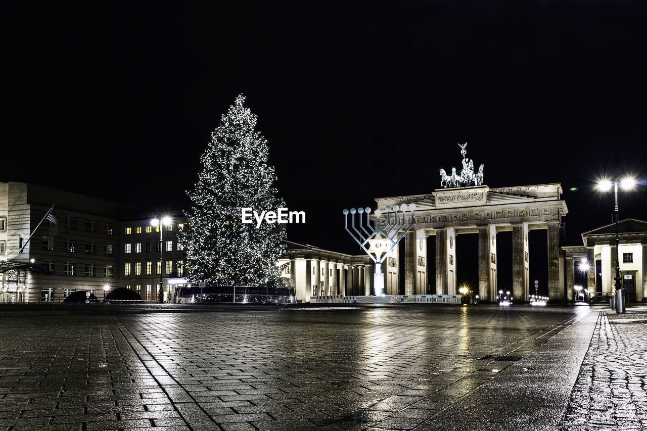 VIEW OF ILLUMINATED CITY AT NIGHT