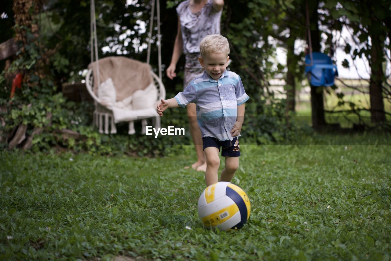 Boy playing soccer on field