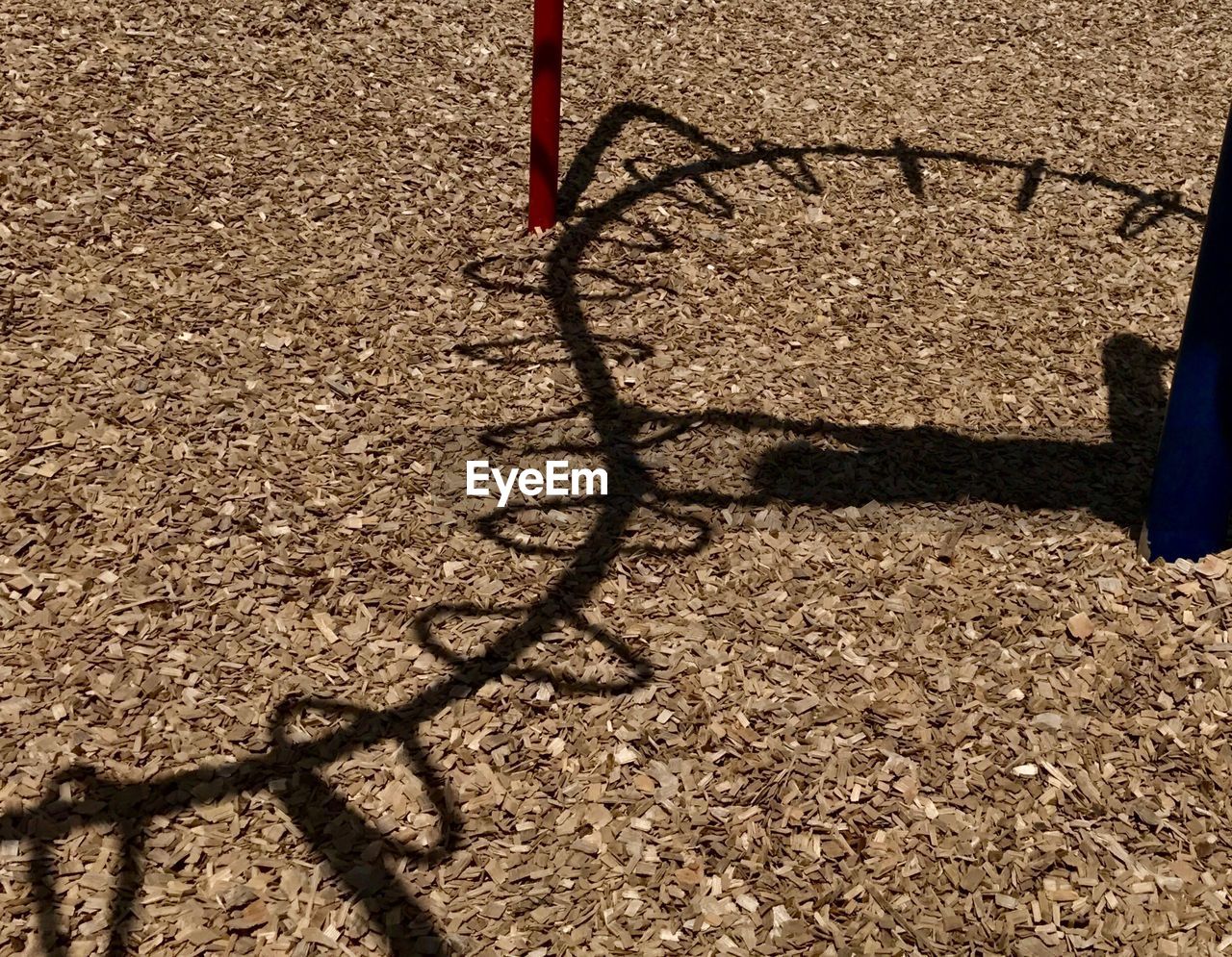 Shadows of monkey bars on the ground 