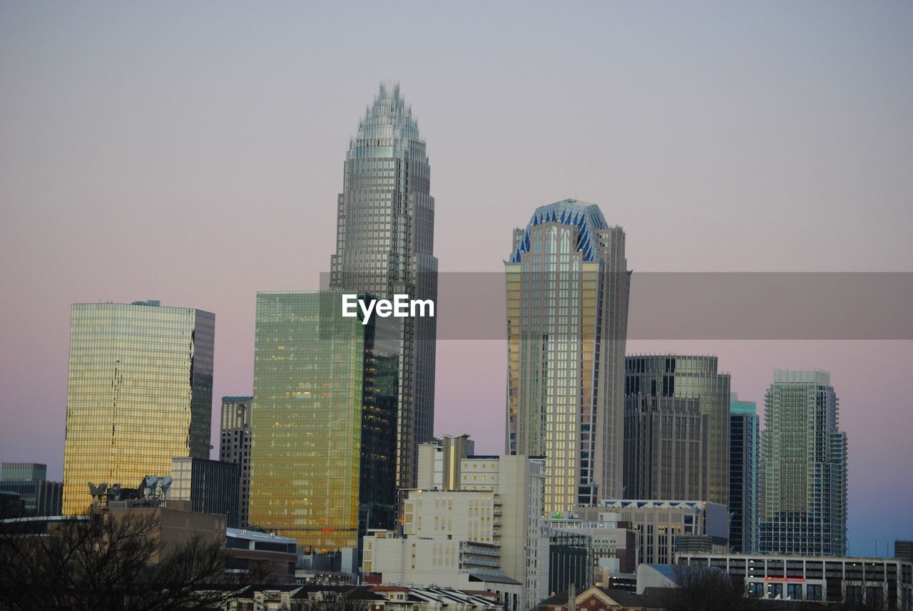 Bank of america corporate center amidst buildings against clear sky in city