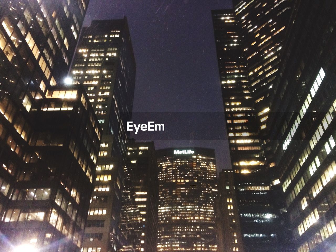 LOW ANGLE VIEW OF MODERN BUILDINGS AT NIGHT