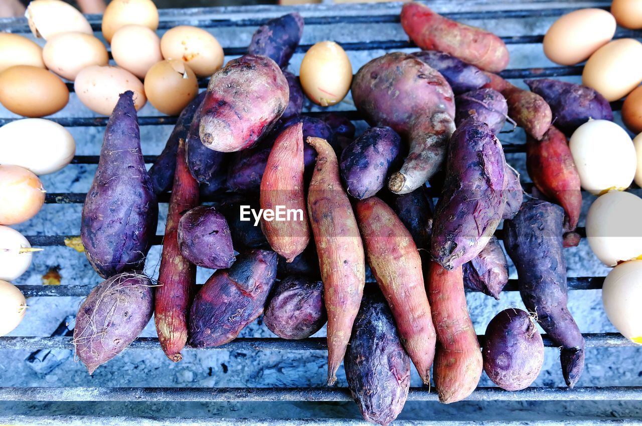 HIGH ANGLE VIEW OF ONIONS AND VEGETABLES ON WOOD