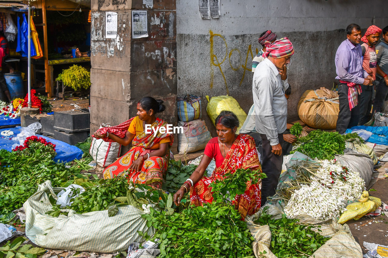 GROUP OF PEOPLE IN MARKET