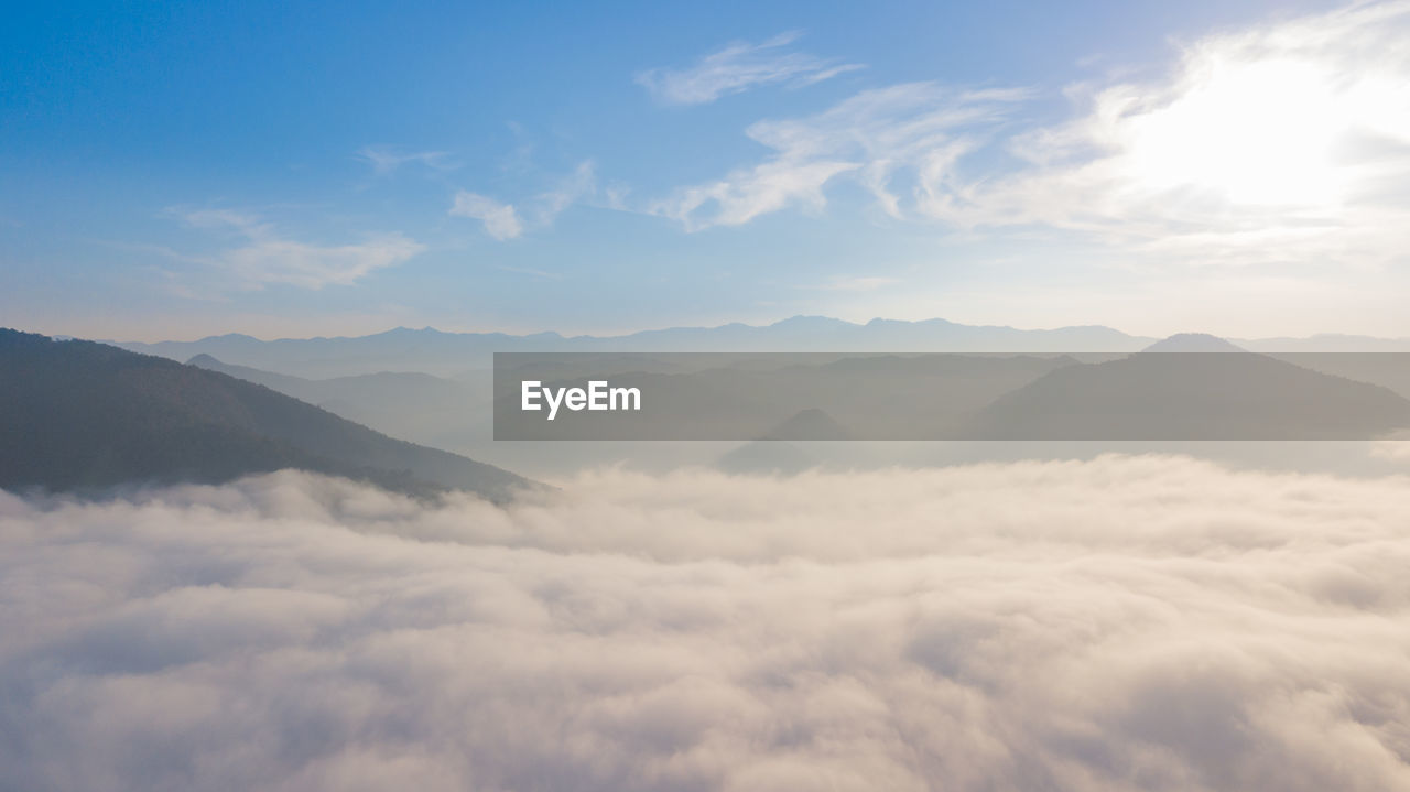 Scenic view of mountains against sky with sea of clouds