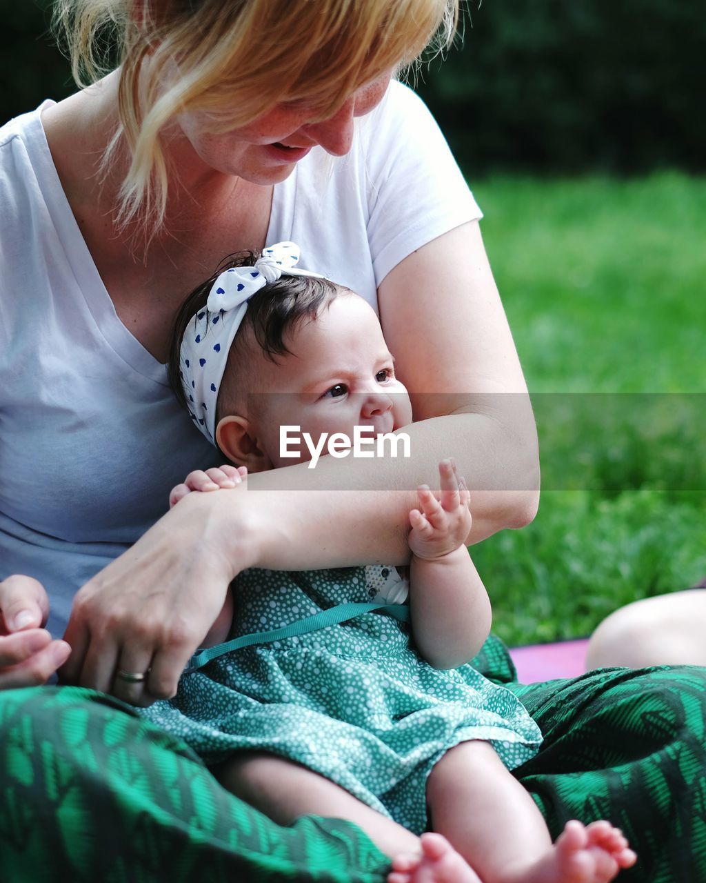 Close-up of daughter biting mother hand