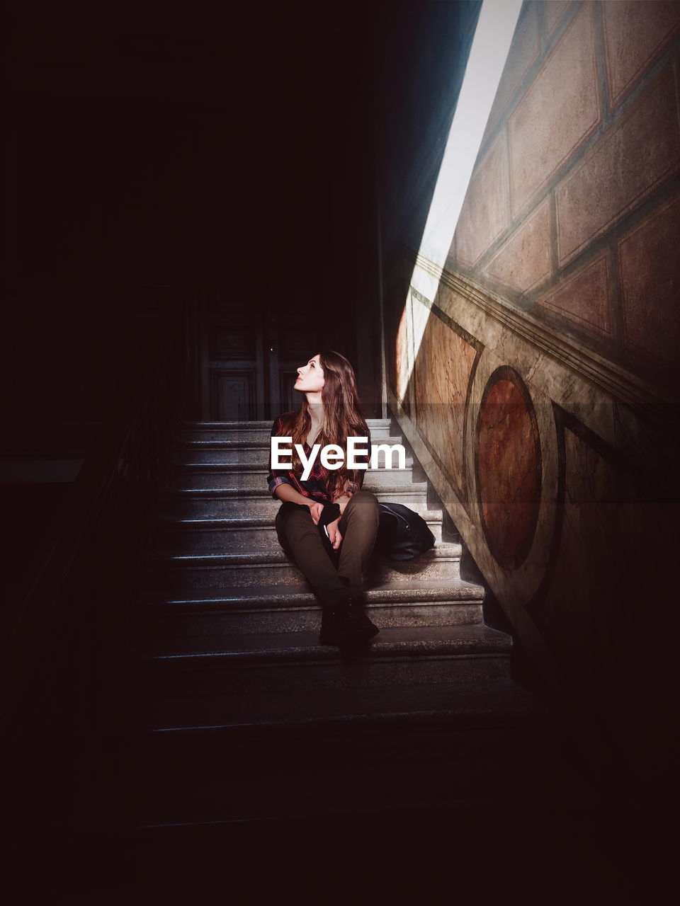 Young woman sitting on stairs