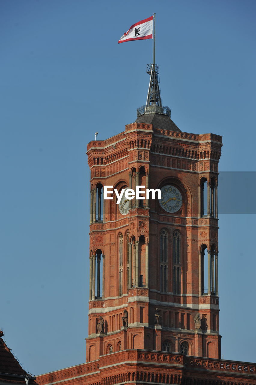 LOW ANGLE VIEW OF BUILDING AGAINST BLUE SKY