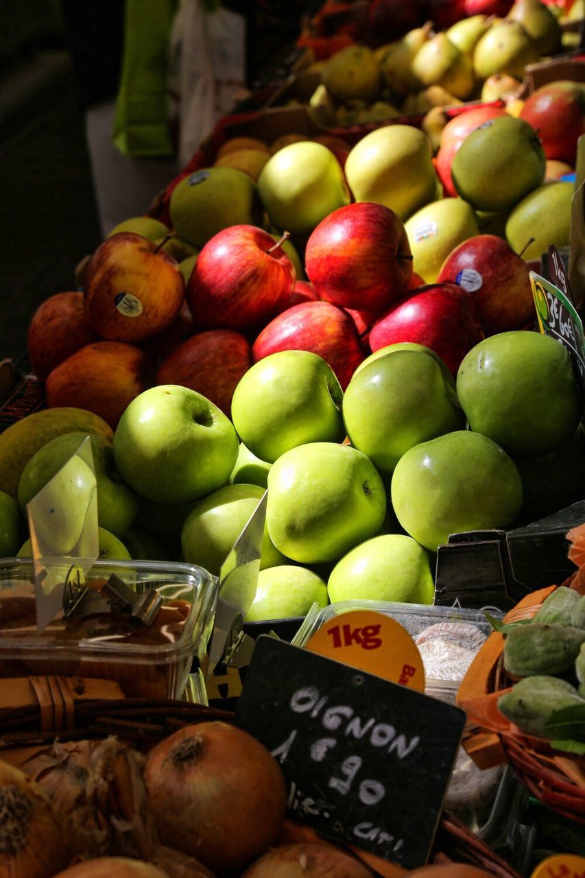 Stacked apples for sale at market stall