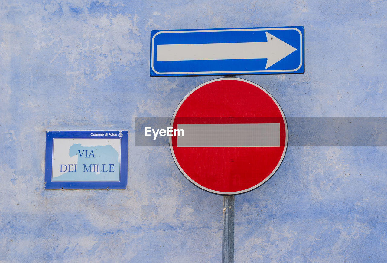 Road signs against wall