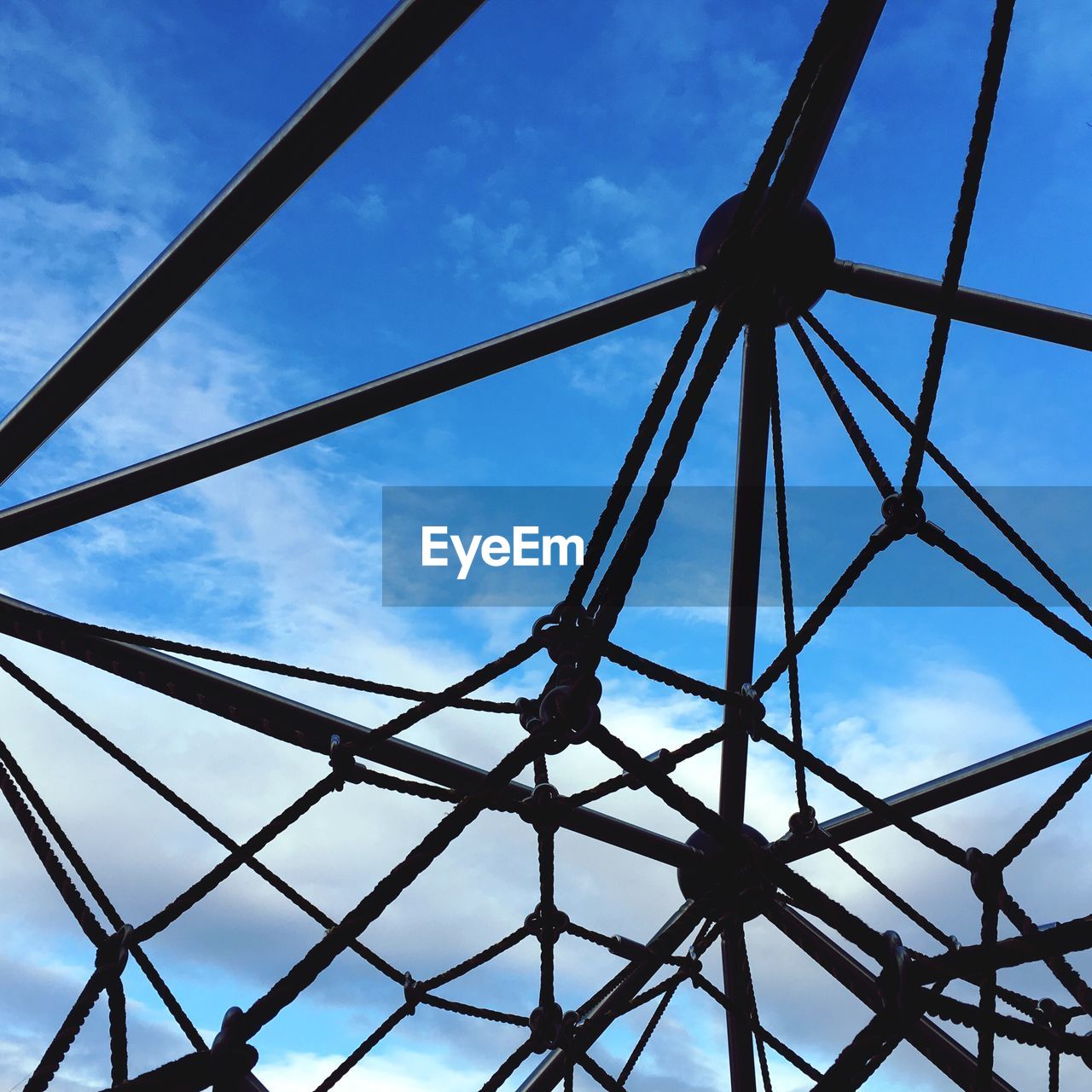 Full frame shot of jungle gym against blue sky