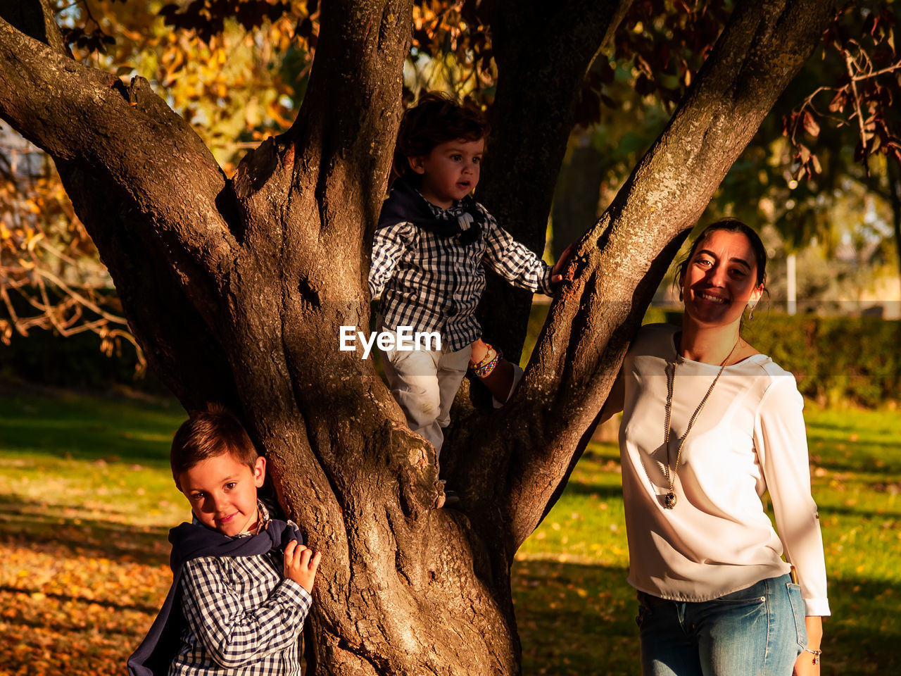 Portrait of mother and sons at park
