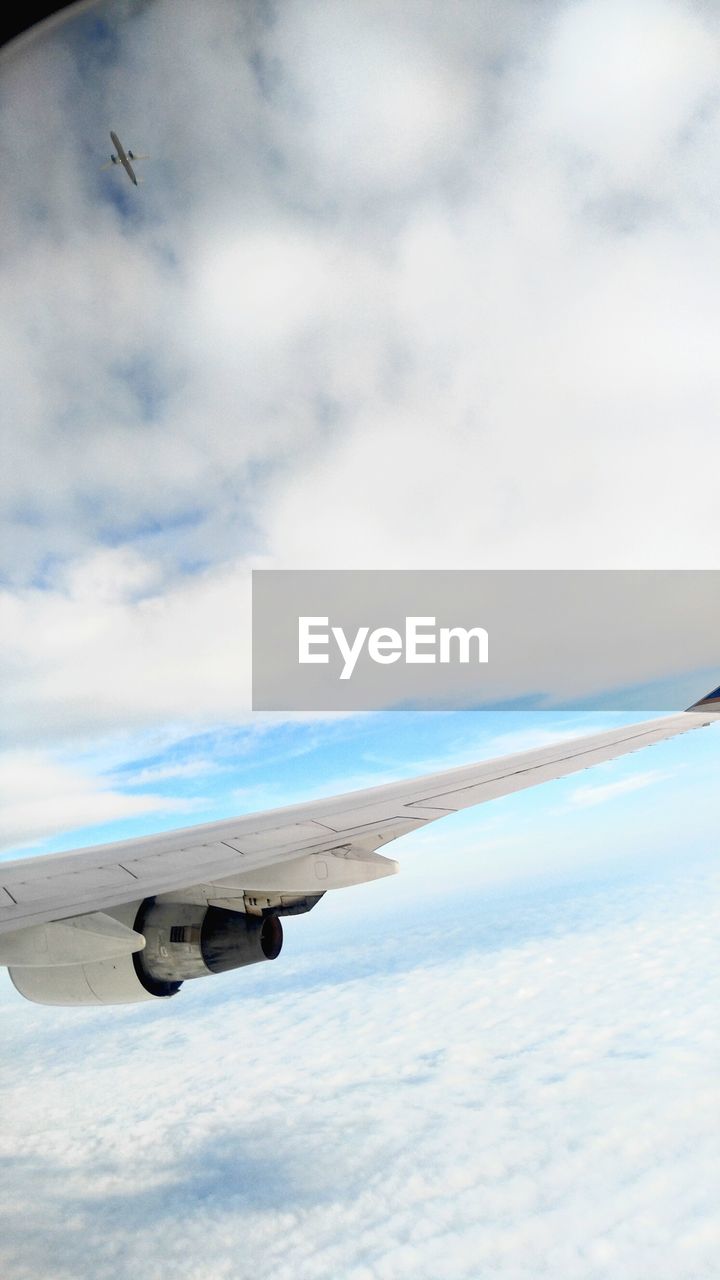 Airplane flying over cloudy sky