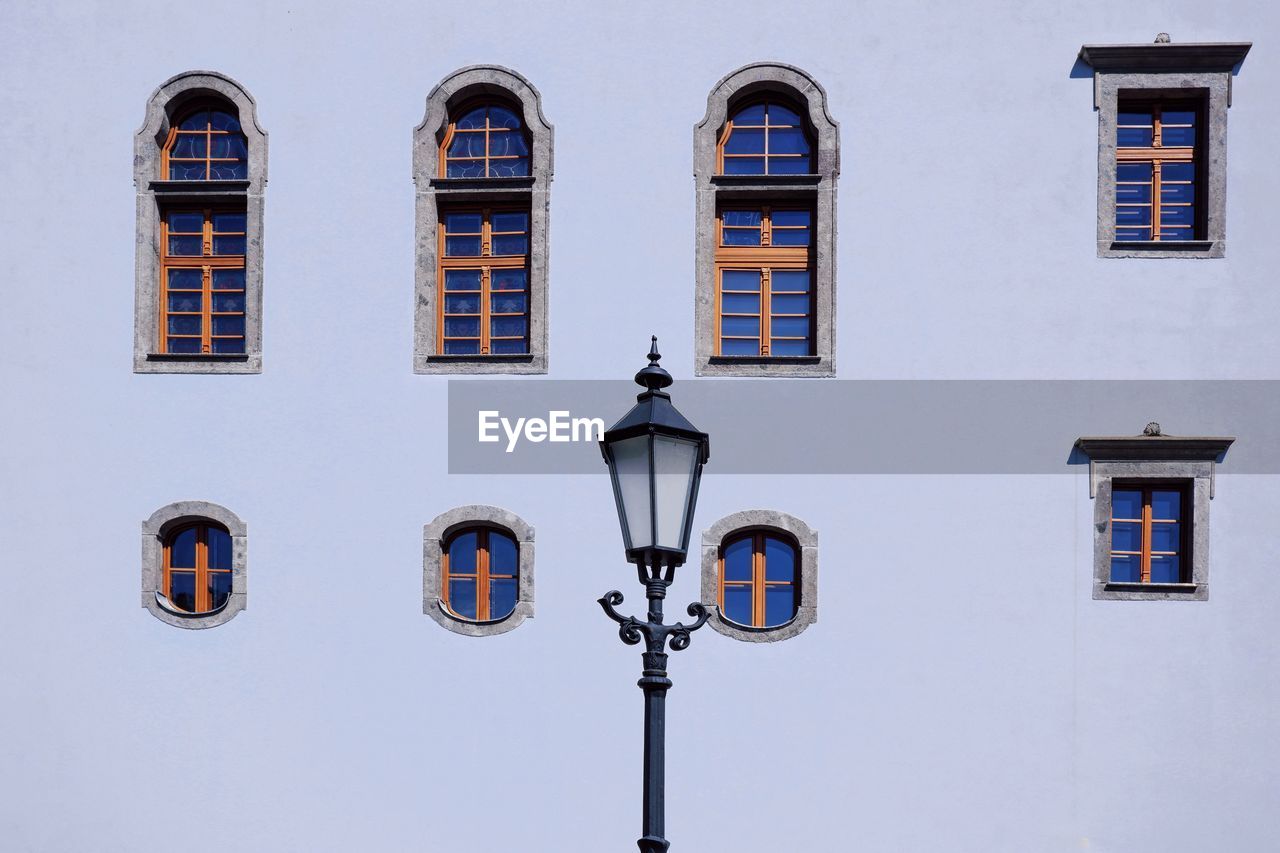 Low angle view of street light against building