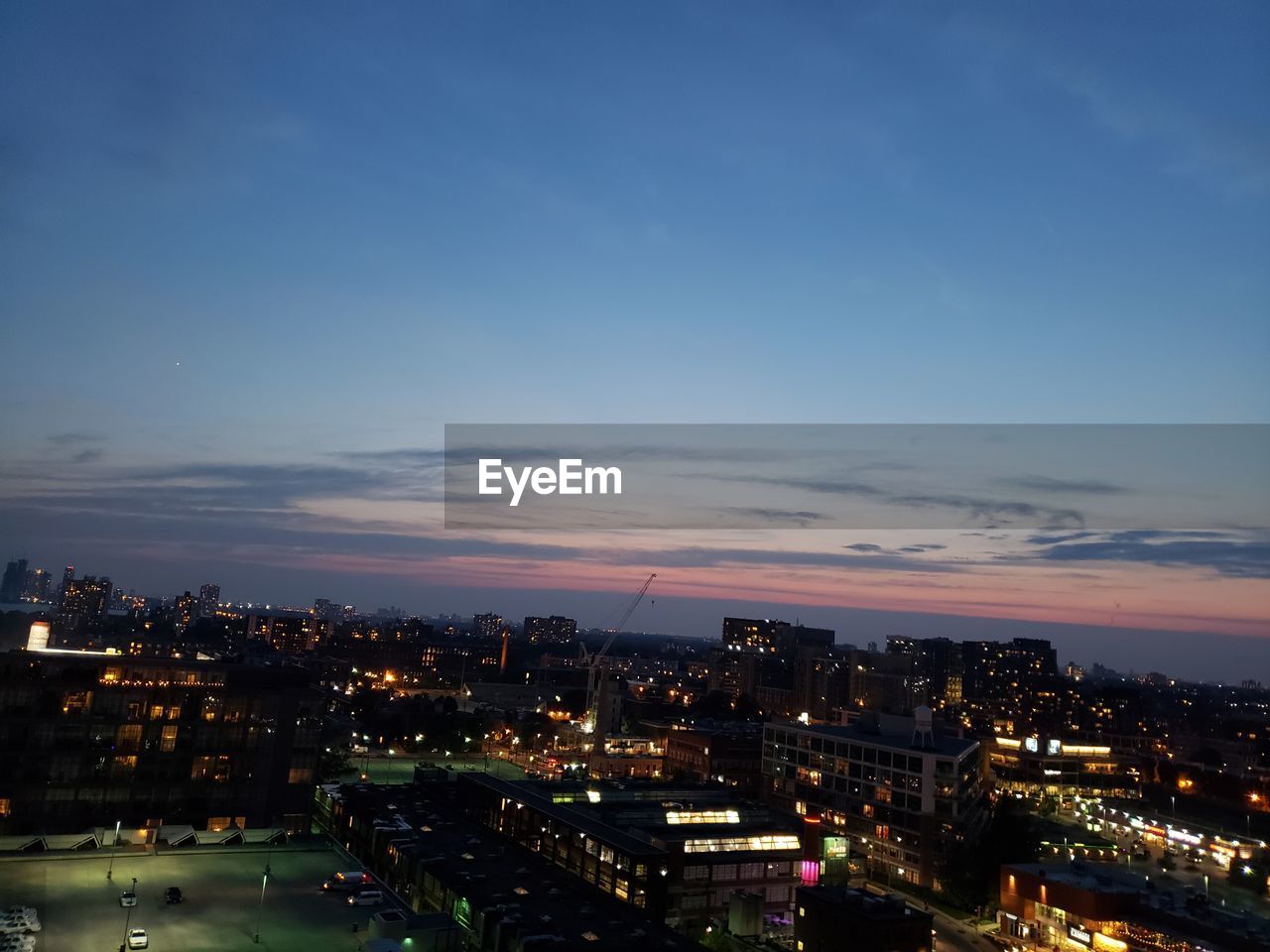 HIGH ANGLE VIEW OF ILLUMINATED BUILDINGS AT NIGHT