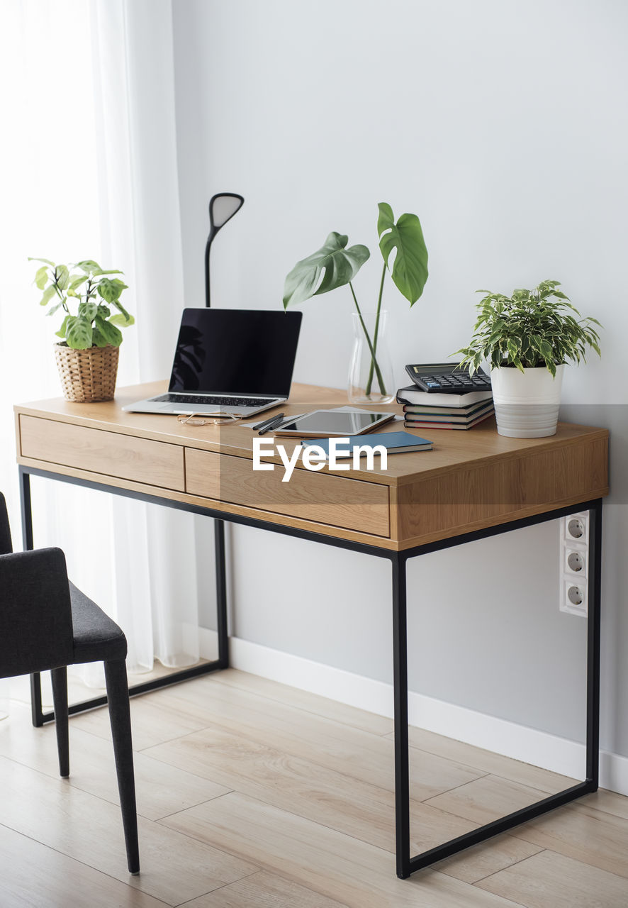 Office workplace with laptop on wooden table