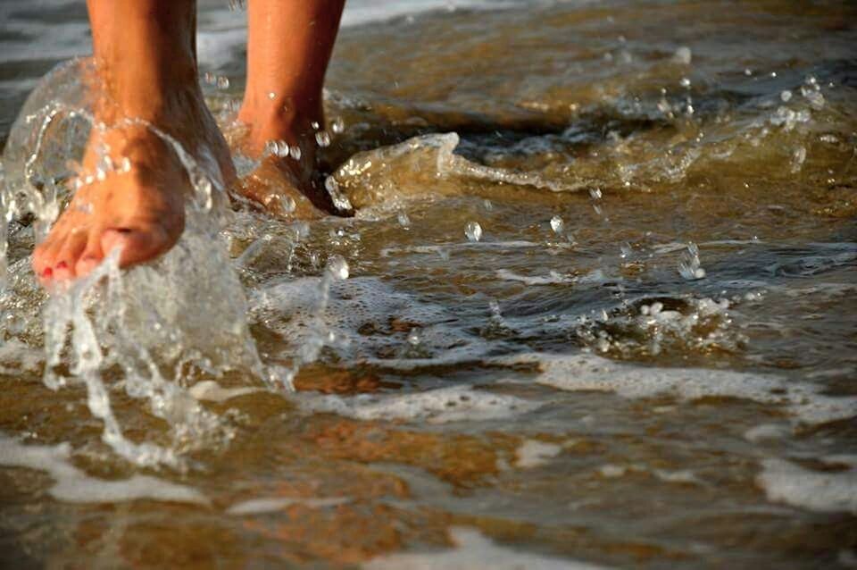 CLOSE-UP OF WATER SPLASHING ON ROCKS