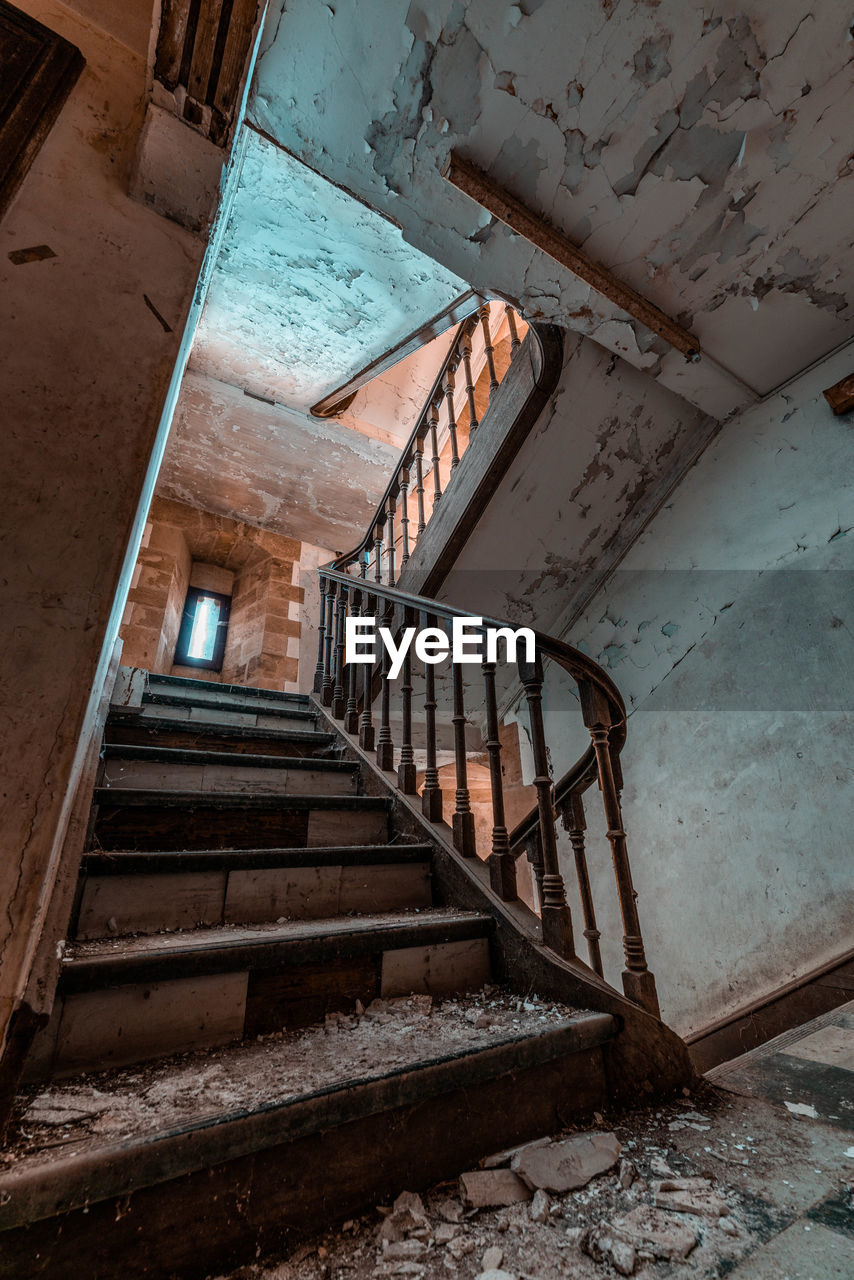 architecture, staircase, stairs, steps and staircases, built structure, abandoned, wall, house, wood, old, building, indoors, rundown, urban area, damaged, railing, no people, iron, ruined, history, deterioration, decline, wall - building feature, weathered, low angle view