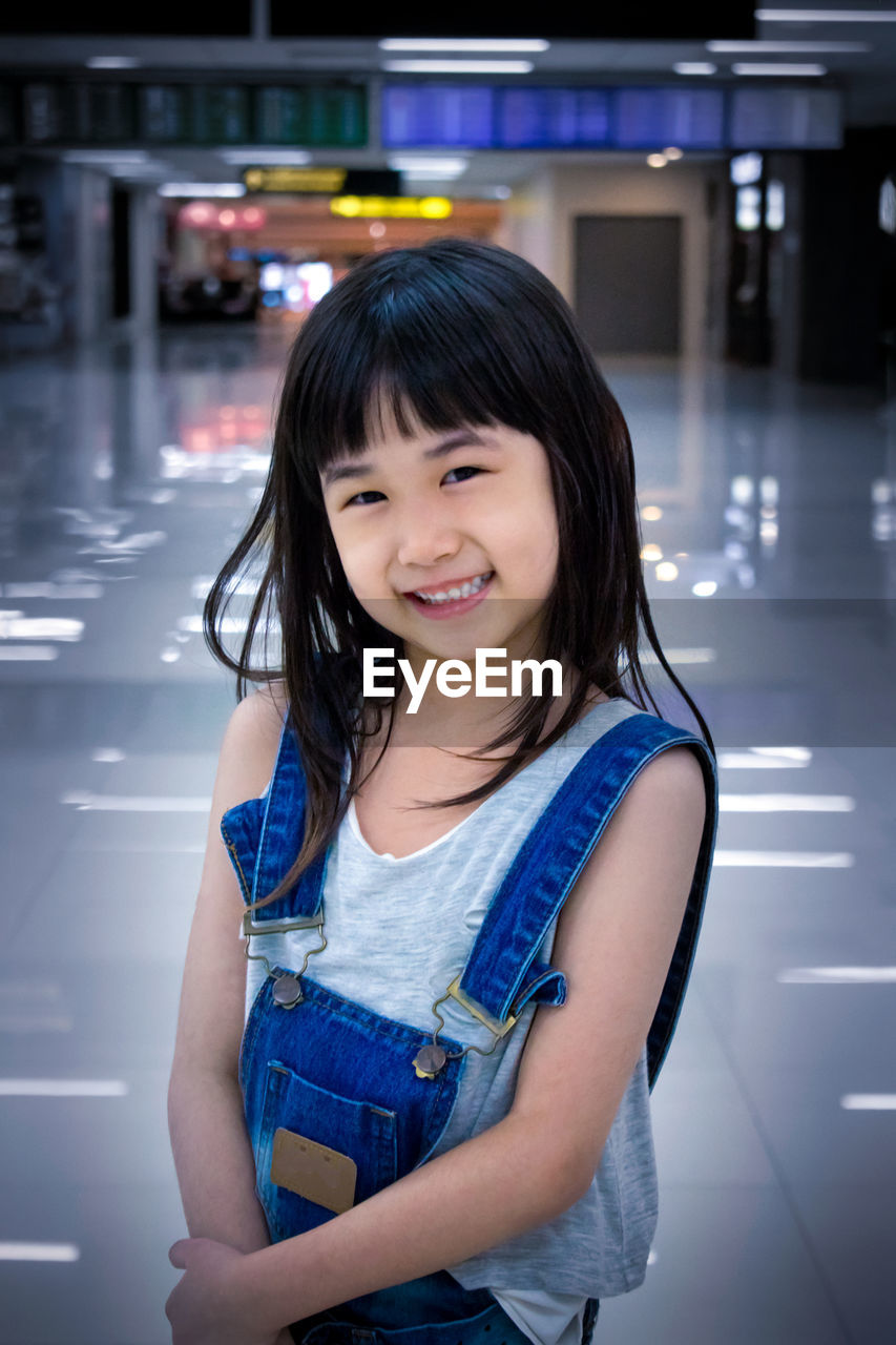 Portrait of girl standing at shopping mall