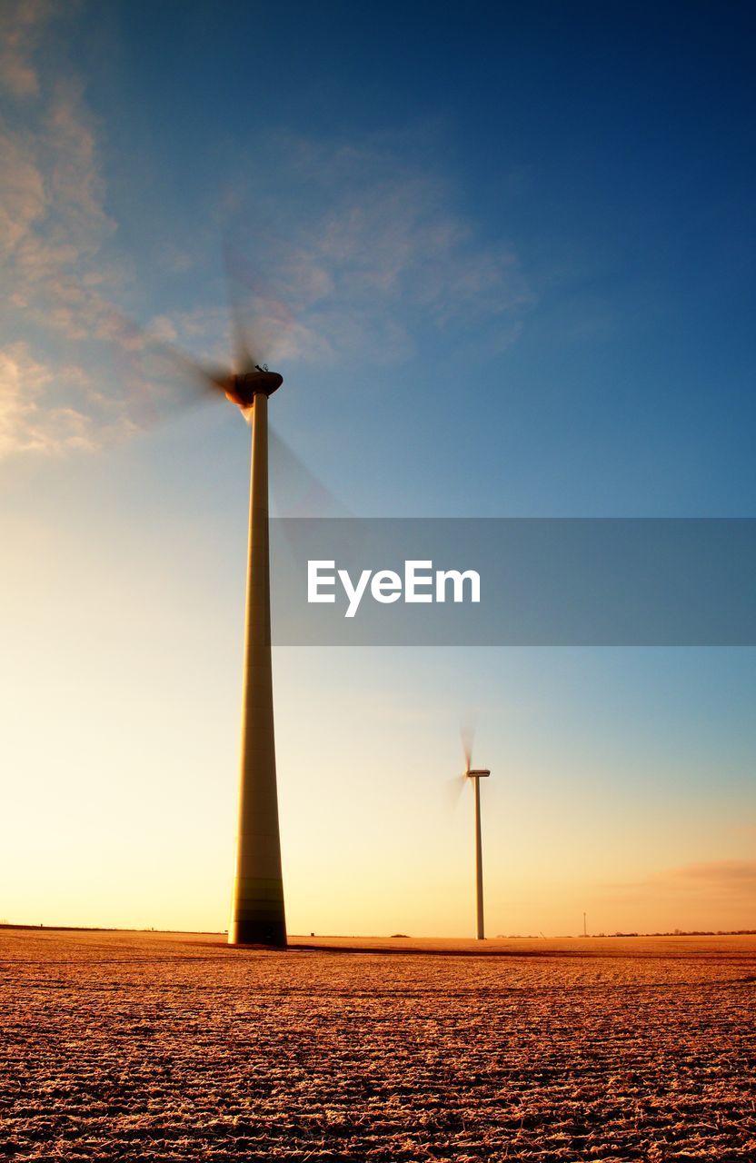 Modern wind turbines producing energy in suny spring morning. vintage style toned effect