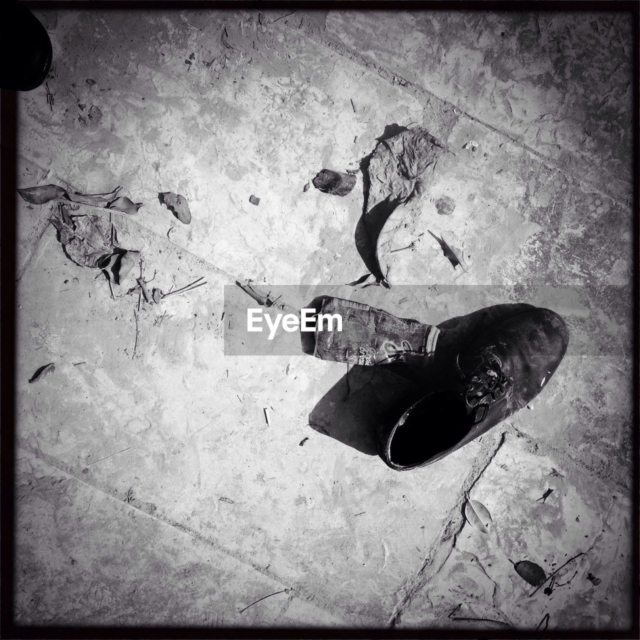 High angle view of abandoned shoe and sock on floor