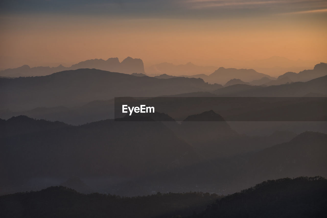 Scenic view of silhouette mountains against sky during sunset