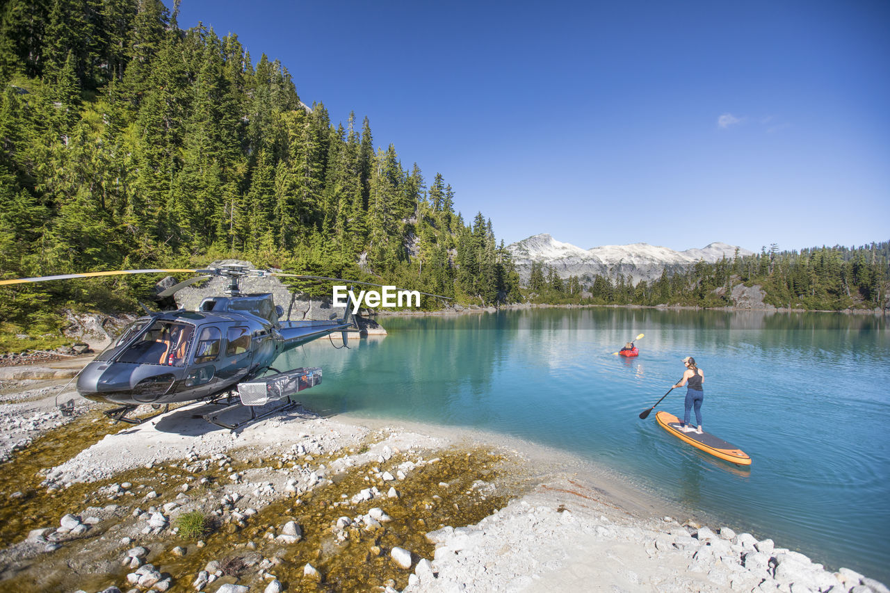 Mother and daughter paddling on stunning blue lake during tour.