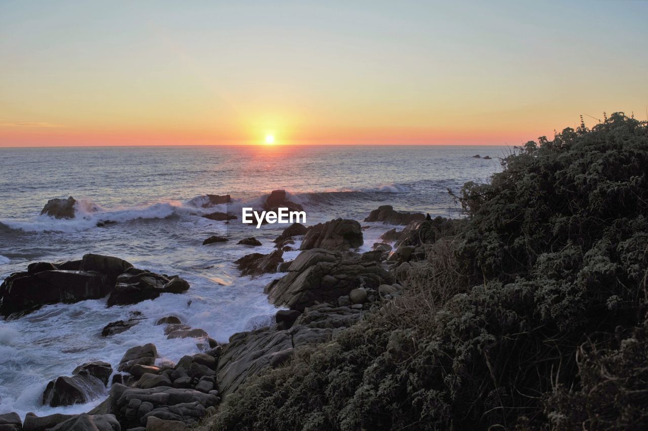 Scenic view of sea against sky during sunset