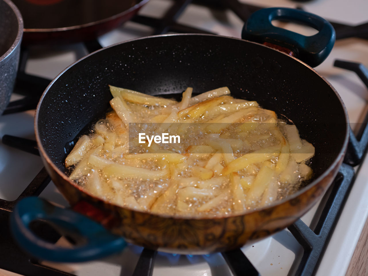 High view of fried potatoes in frying pan