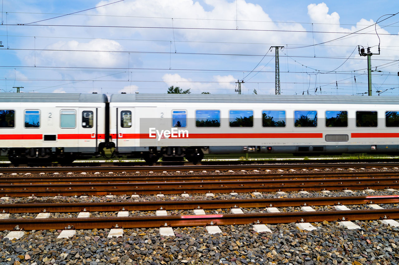 Passenger train on tracks against sky