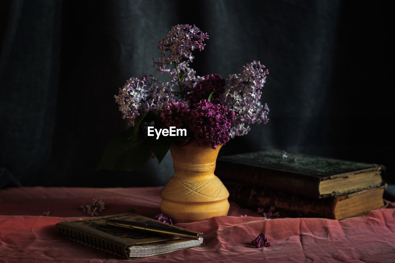 Close-up of pink flower vase on table