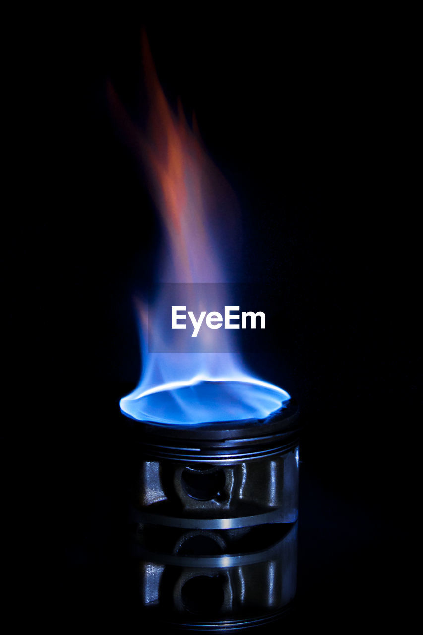 Close-up of flame on black background
