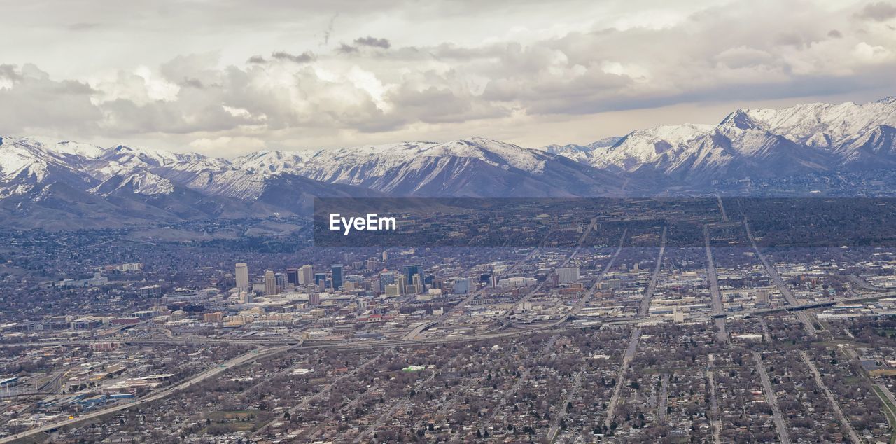 AERIAL VIEW OF CITYSCAPE AND MOUNTAINS