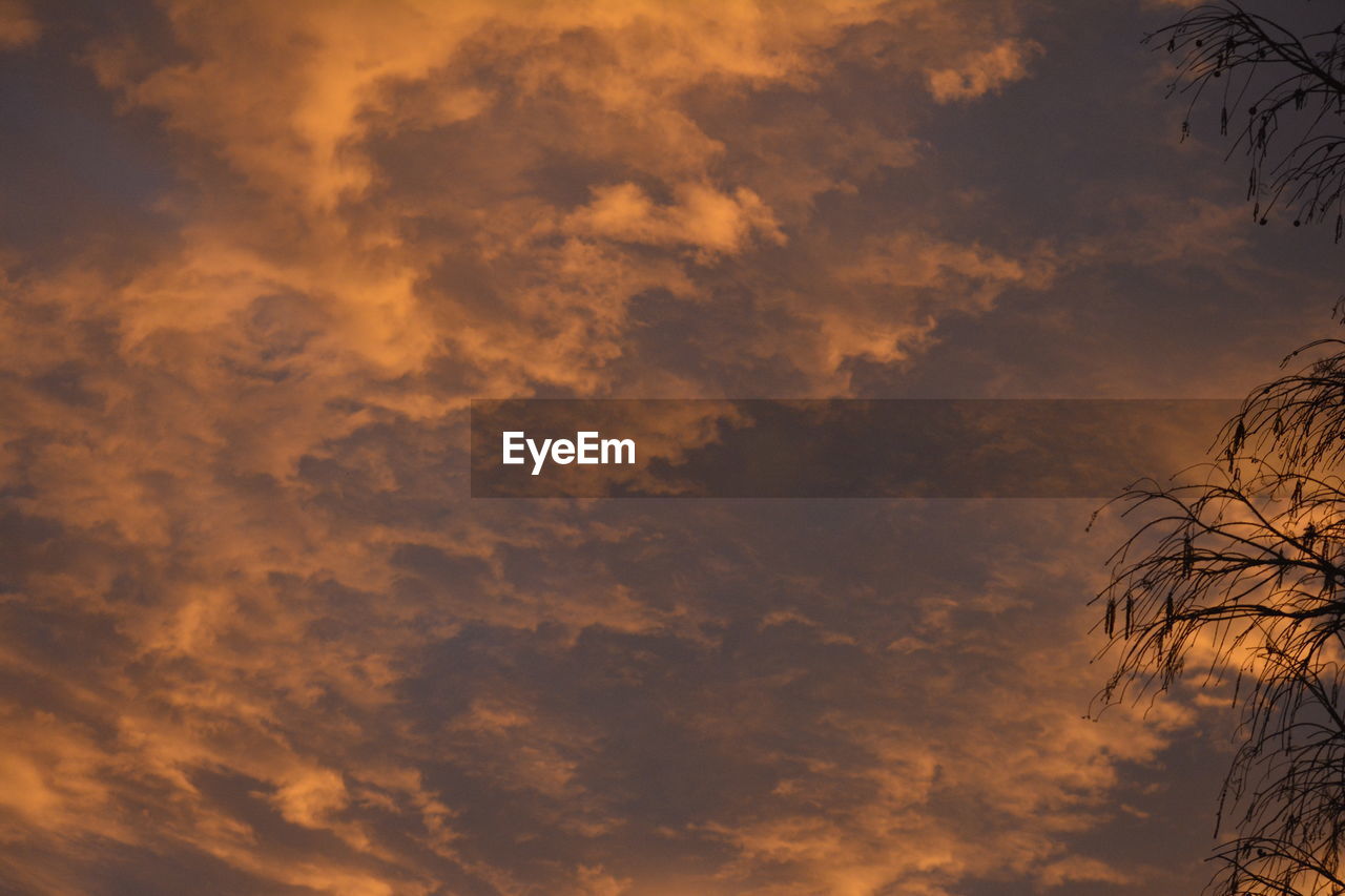 Low angle view of dramatic sky during sunset