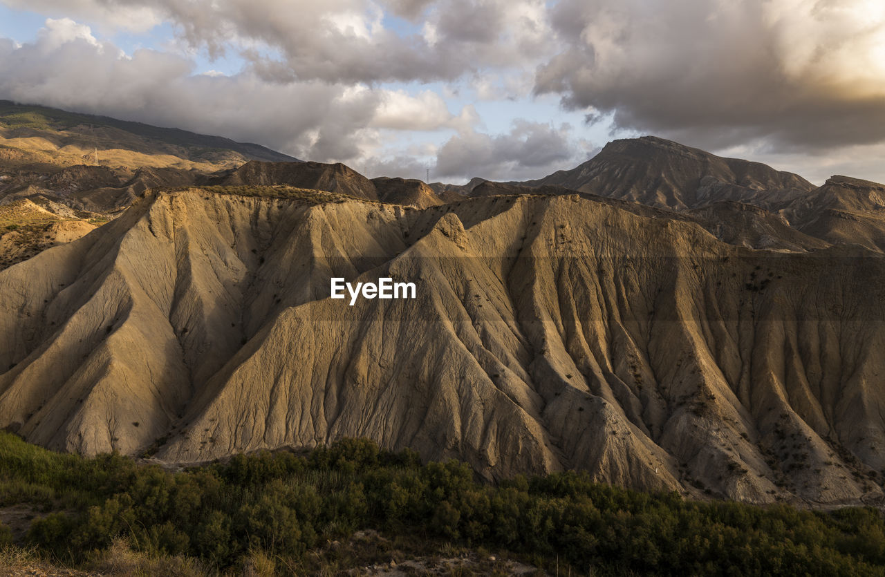 Panoramic view of landscape of tabernas desert in almeria, spain, against cloudy sky