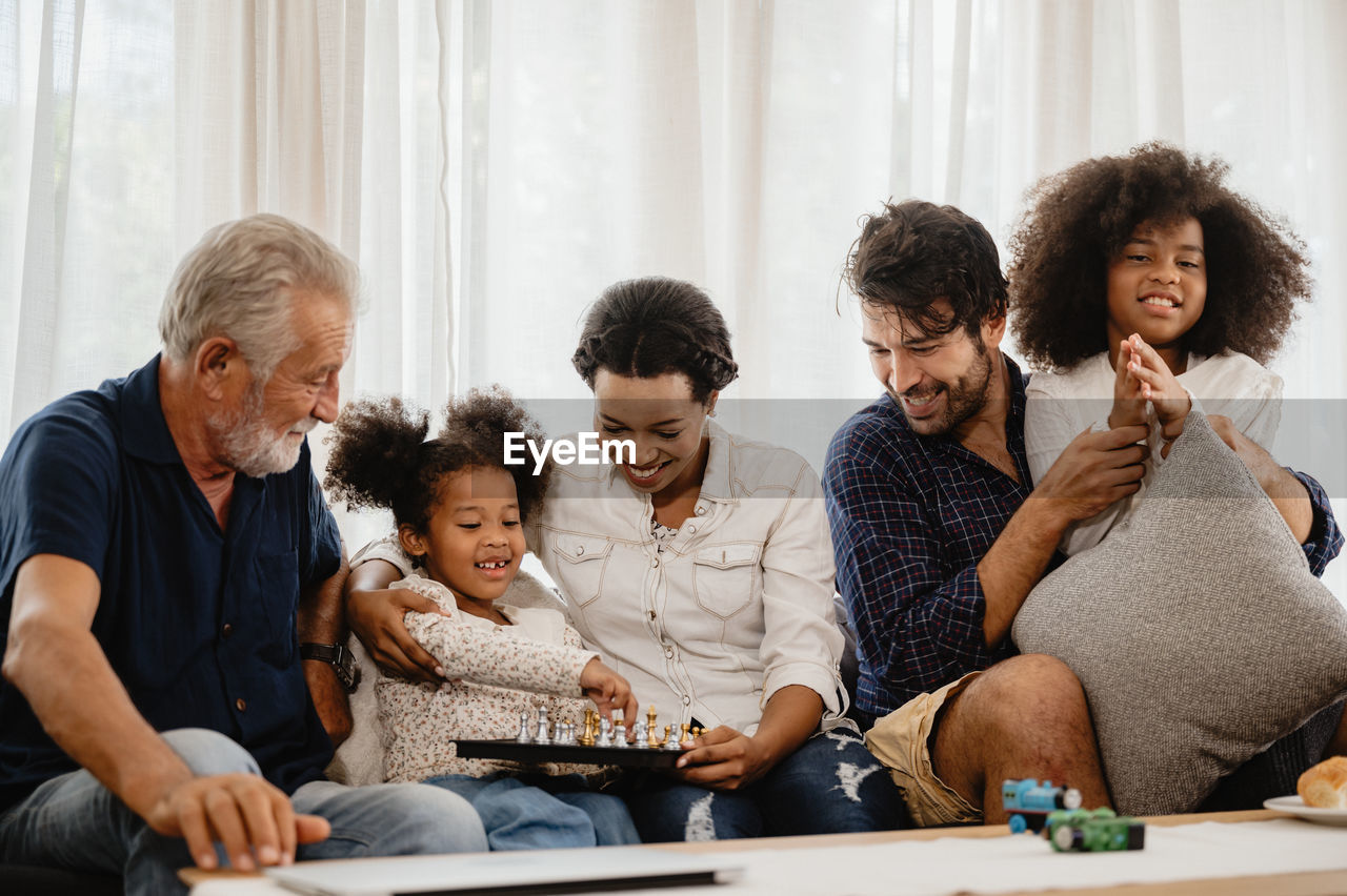 GROUP OF PEOPLE SITTING ON THE FLOOR