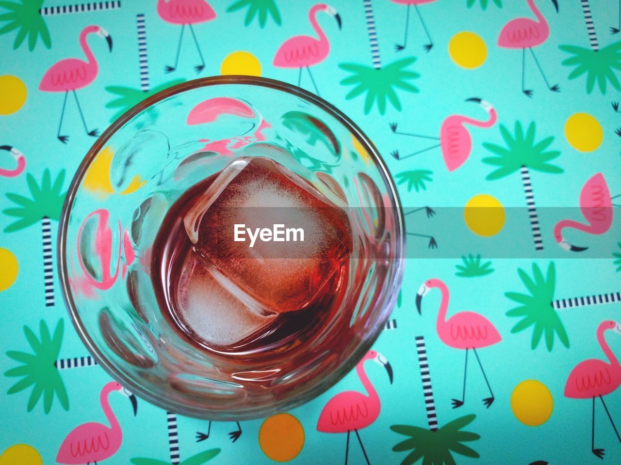 High angle view of red drink in glass on table