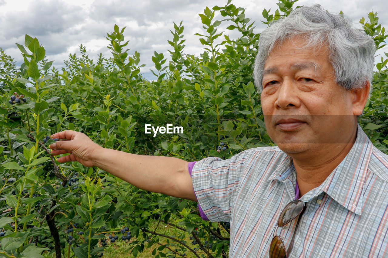 Portrait of man standing in farm