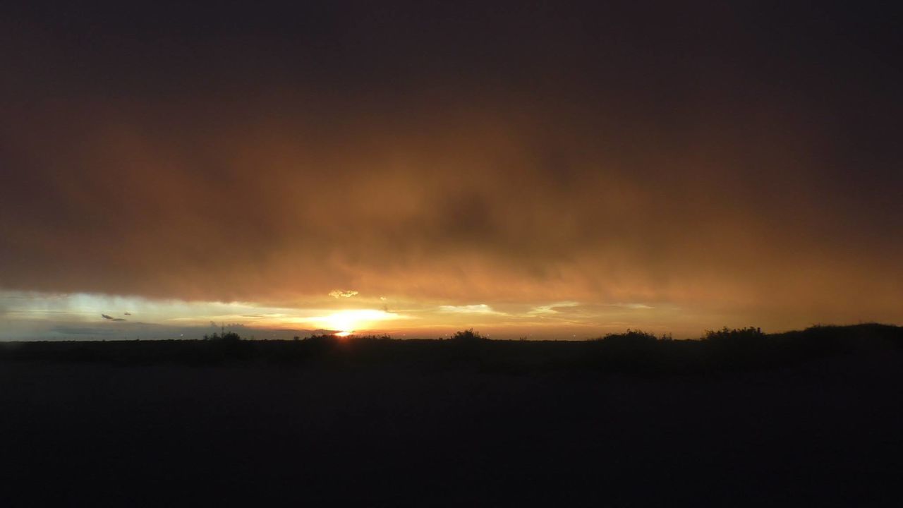 SILHOUETTE LANDSCAPE AGAINST DRAMATIC SKY