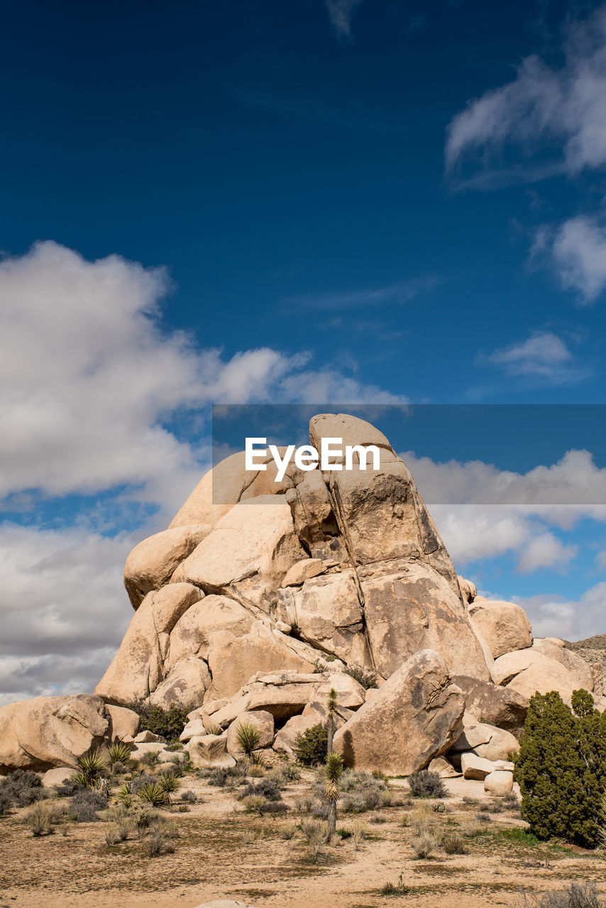 Large stone grouping against blue sky in joshua tree national park