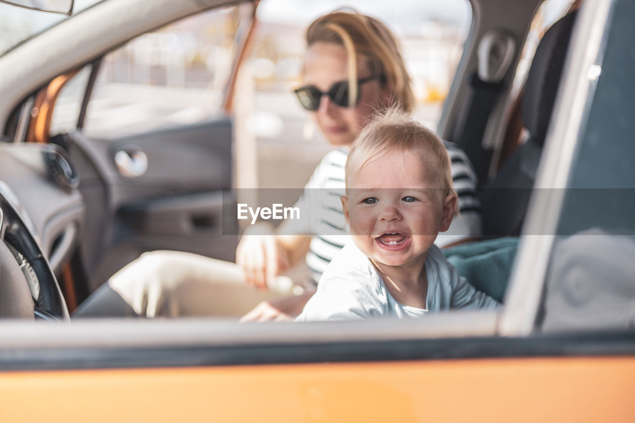 portrait of young woman in car