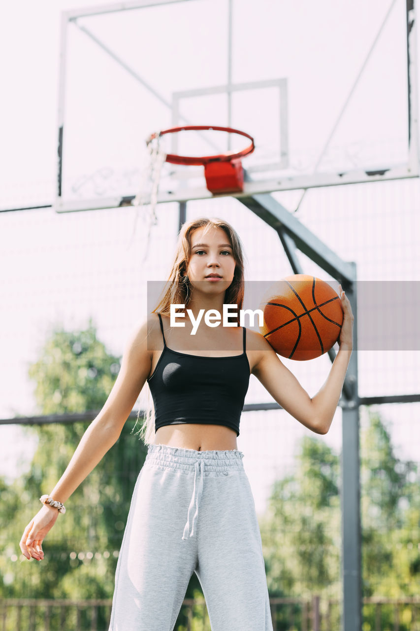 Portrait of young female basketball player. beautiful teen girl playing basketball. 