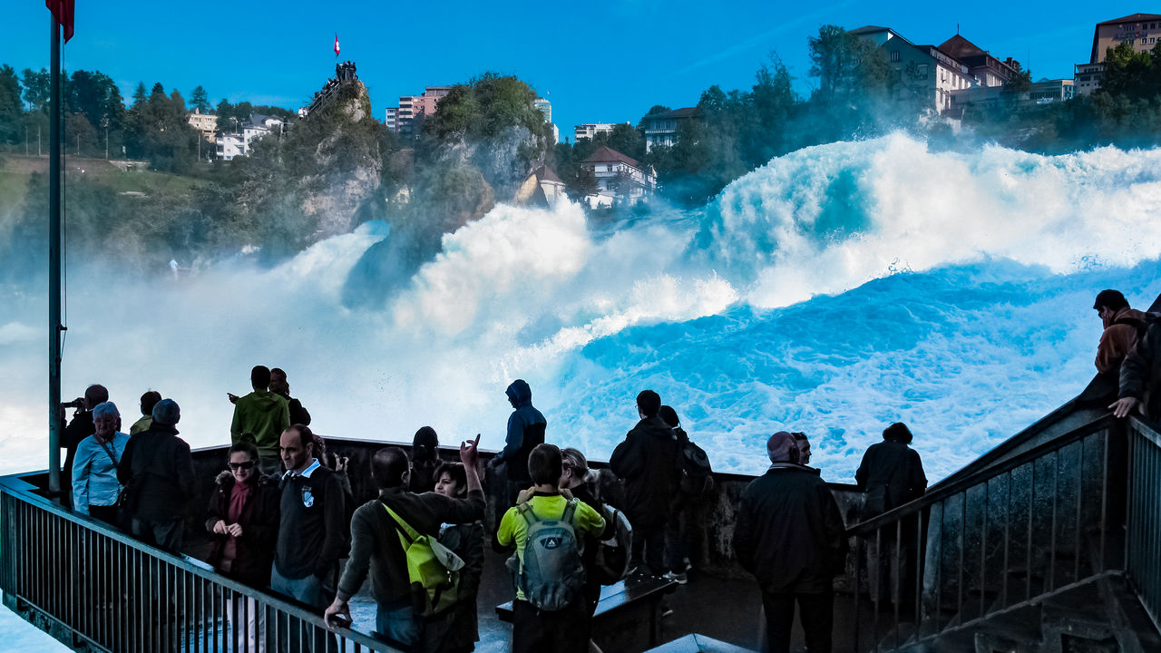 PANORAMIC VIEW OF PEOPLE LOOKING AT VIEW OF BUILDINGS