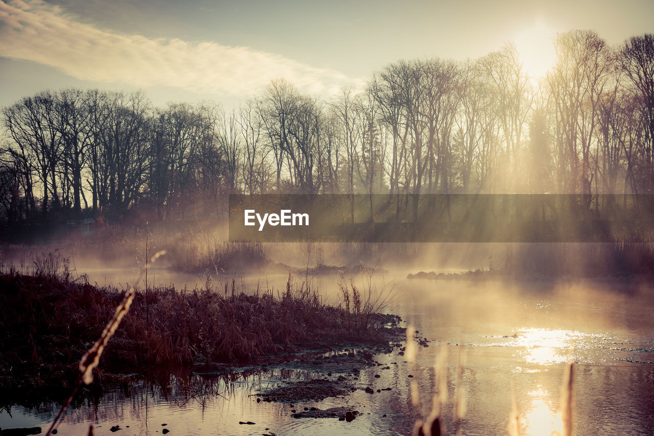 Scenic view of lake against sky during winter