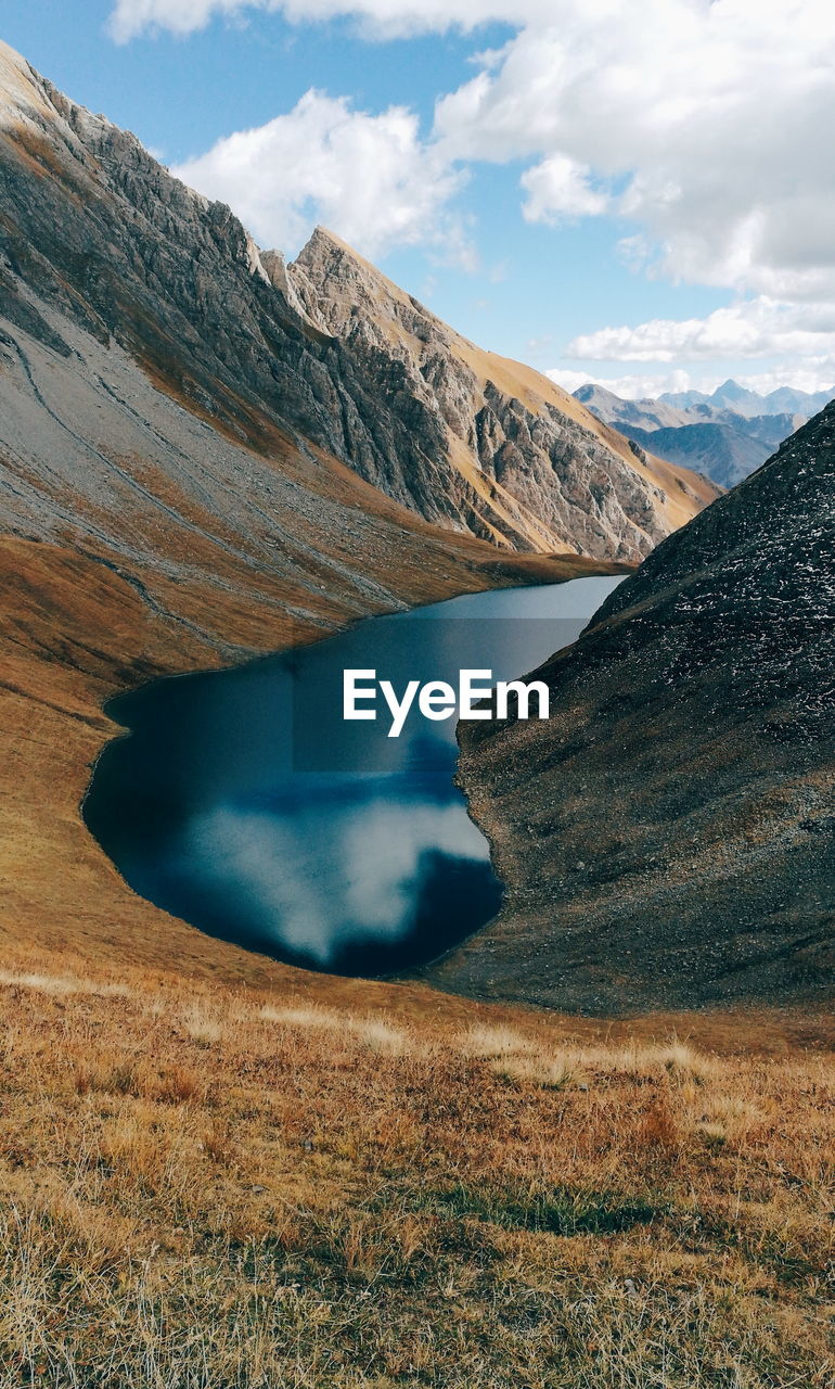 Scenic view of lake and mountains against sky