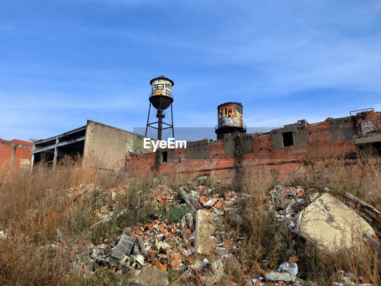 Low angle view of abandoned buildings against blue sky