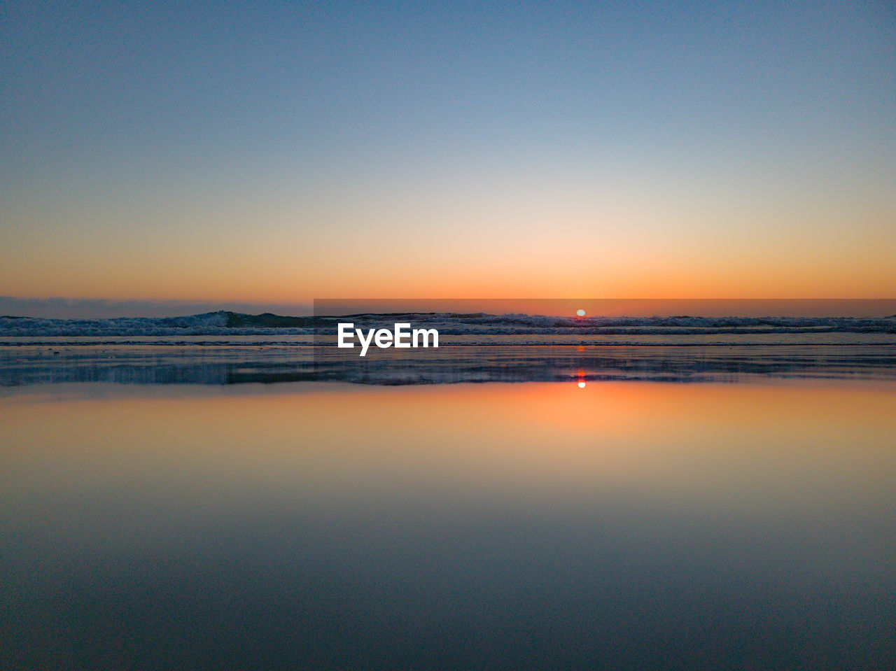 Scenic view of sea against clear sky during sunset