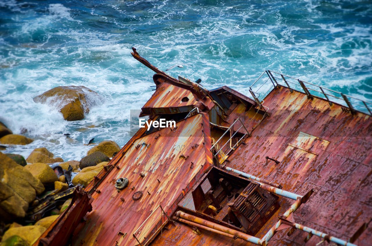 High angle view of rusted deck at sea shore
