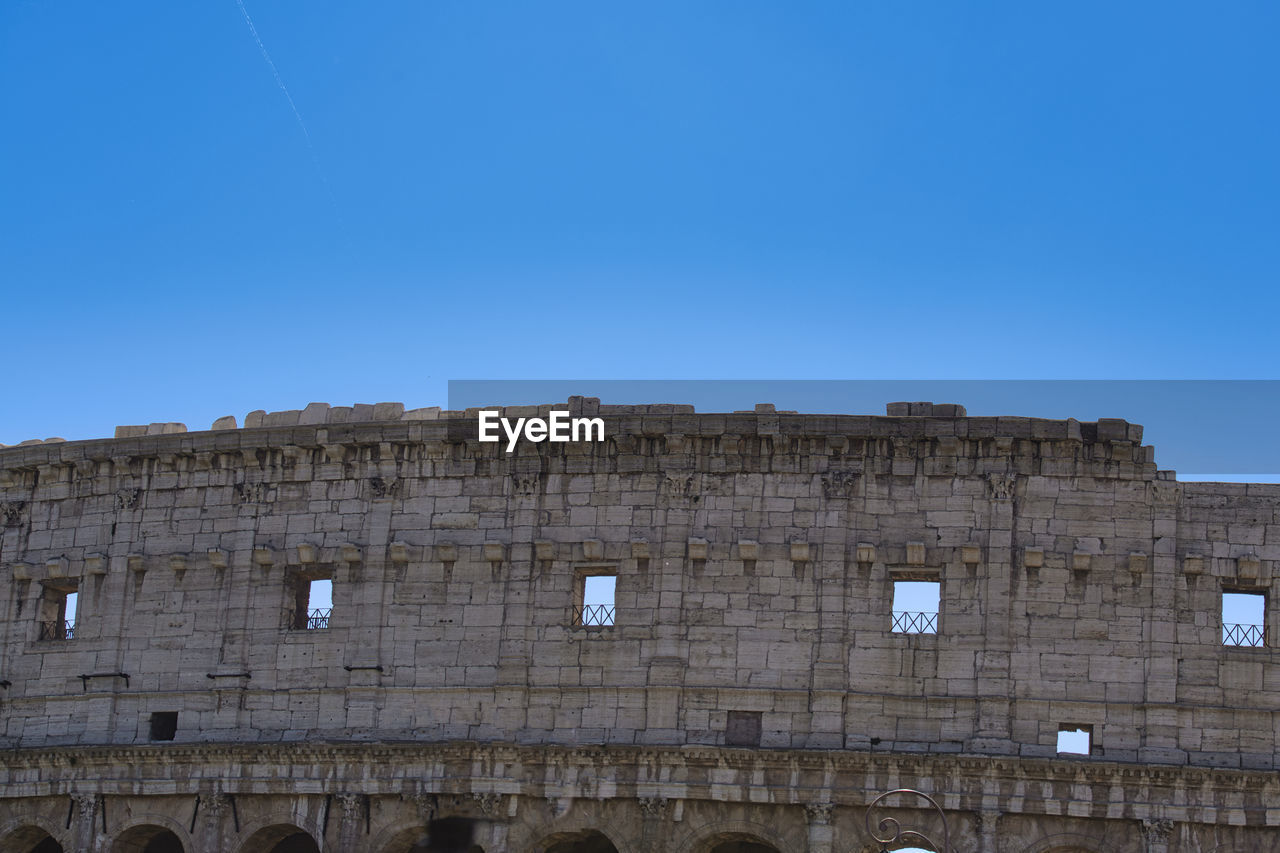 LOW ANGLE VIEW OF BUILDING AGAINST BLUE SKY