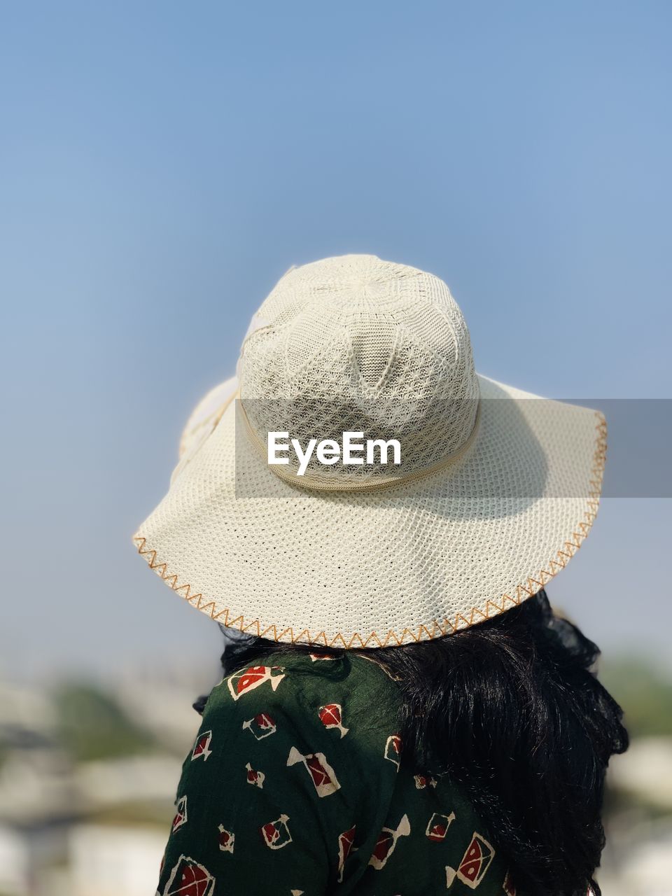 hat, clothing, one person, rear view, adult, cap, women, nature, sky, day, fashion accessory, clear sky, outdoors, focus on foreground, copy space, portrait, headgear, headshot, sun hat, blue, sunny, lifestyles, leisure activity